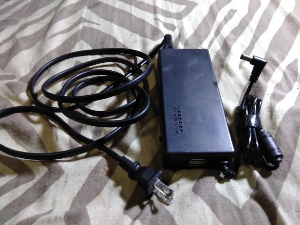 Universal Lab Top Charger With Two USB Ports Built-in On The End And A Selector Switch So You Can Change The Voltage Output