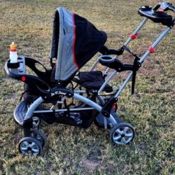 A stroller for two children. A set of dishes and bottles, new . for juice and milk.