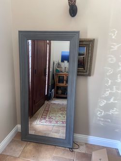 Blue standing mirror with faux stud detail