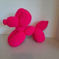 Hot pink crocheted balloon dog plushie 