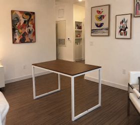 Modern dining table with walnut finish top and white metal frame