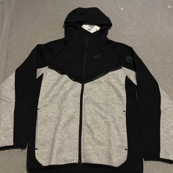 Grey and Black Nike tech. Medium ( a little smaller then a medium), fits a small.