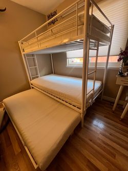 White twin bunk bed with trundle and mattresses