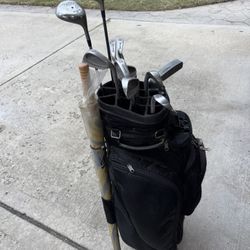Full set of Spalding RH golf clubs w/ bag on wheels w/ carry on shoulder strap w/ balls & tees. 
