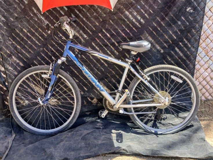 This appears to be a blue and silver Schwinn Sierra Sport hybrid bike.