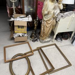 A collection of antique wooden and gilded picture frames.