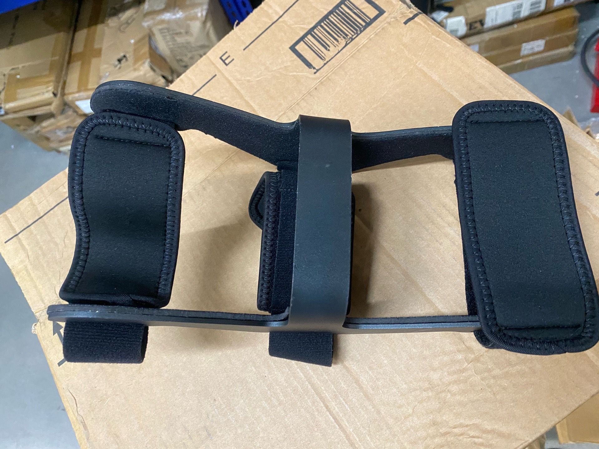 Hyperextension knee brace with adjustable straps