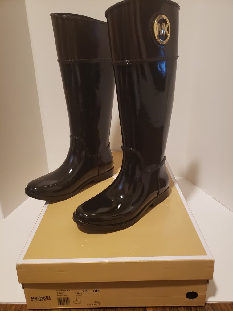 Brand New Michael Kors Stockard Tall Rain Boots In Black w/Gold Logo - Size 8. Condition is New with box.