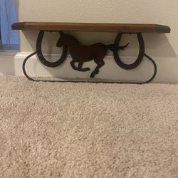 Rustic western style, wood and metal wall shelves with running horseand horseshoe accent include hanging bar for towels