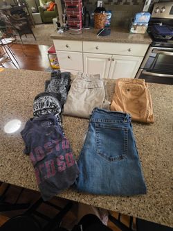 5 men's items three men's medium t-shirts and three pairs of 30x30 jeans khakis and Columbia hiking  pants