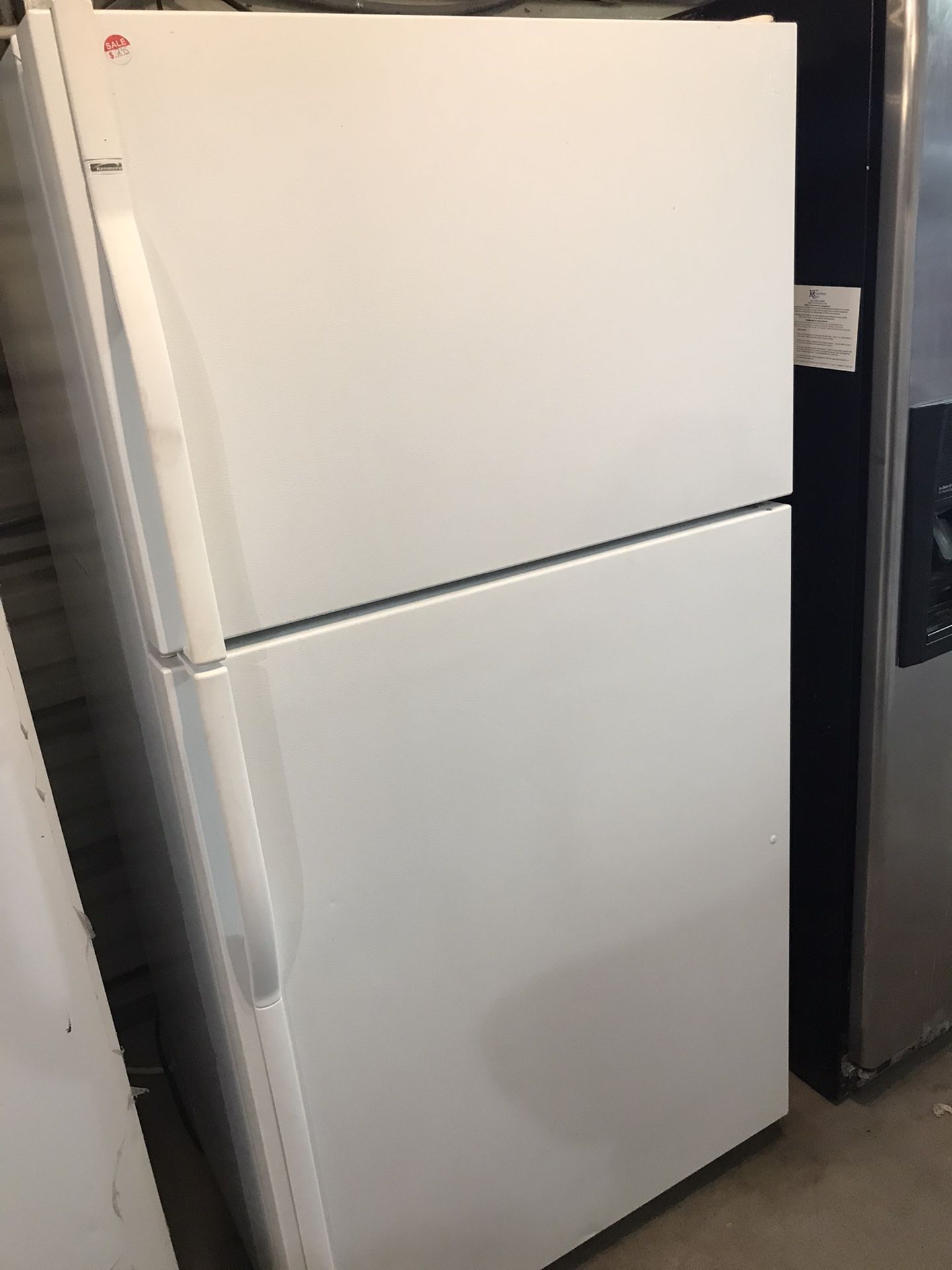 Kenmore refrigerator white color top freezer bottom refrigerator with a 90 day warranty we finance