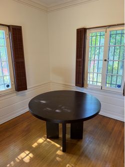 Round black wooden dining table