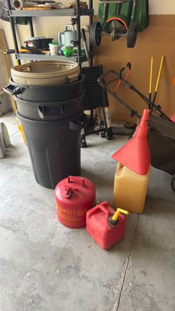Three gas cans and four garbage cans Three gas cans, and four garbage