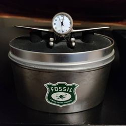 Like-new authentic Fossil table airplane clock.