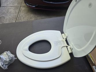 Toilet Seat With Potty Training Seat Attachment.