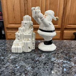 Ceramic Santa Delivering Presents White and Gold Pair of Salt and Pepper Shakers.  Size Santa is 5 1/2 inches tall.  Preowned never used. 