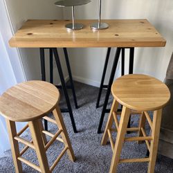 wooden bar table and stools