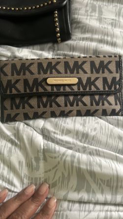 Michael Kors Black Canvas Wallet  MK on from and back of wallet. Gold Michael Kors plate on front and back zipper. Credit card slots, back zipper, and