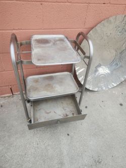 Cart on wheel with trays that lift off and a drw. And a round tray hang on wall