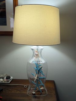 Glass Lamp with Seashells and Starfish Decorations.