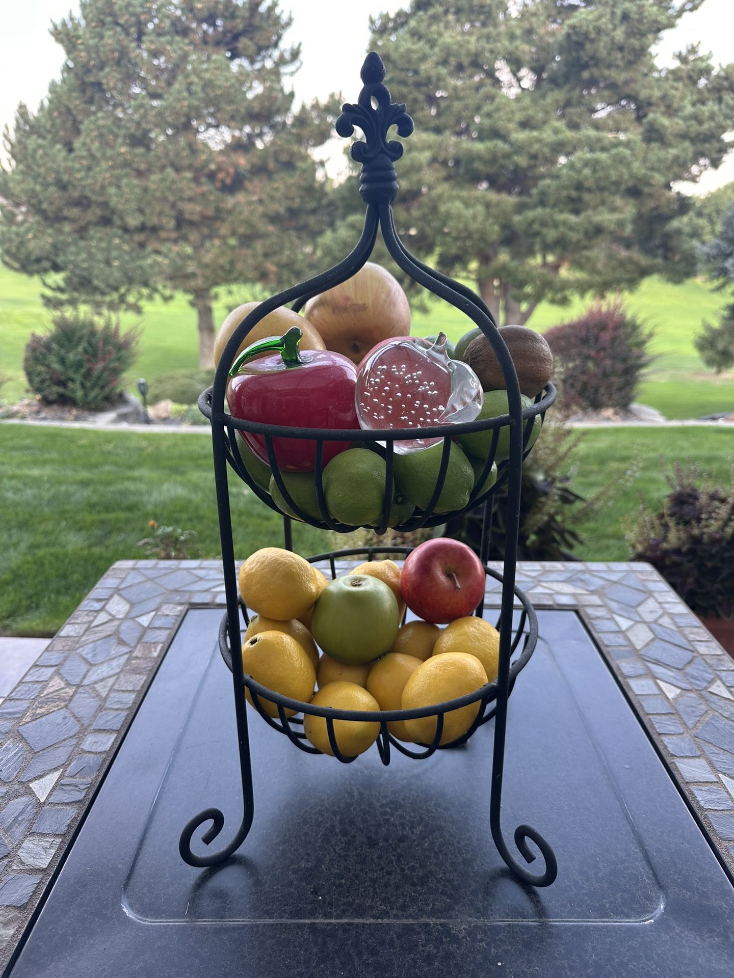🍎Heavy Metal fruit basket with fake fruit. 2 of the 3 apples are glass. Measures 22” tall and 10” diameter