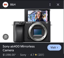 Sony A6400 with 2 lenses, battery grip, 6 batteries, 2 chargers, and 1 128 GB SD Card
