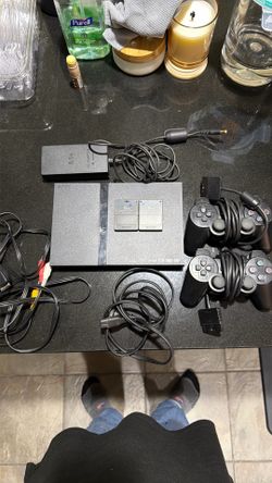 PlayStation 2 slim with 2 OEM memory cards and 2 OEM controllers