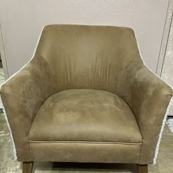 Tan suede-look accent chair with light wood legs and white trim