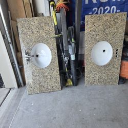 granite counter tops with sinks . four of them