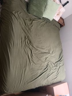 Queen sized bed with mattress and box spring.