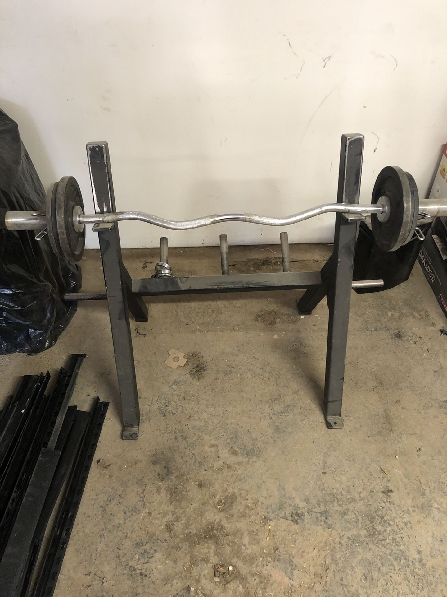 Curl bar with stand and weights.
