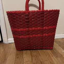 Red hand woven plastic tote
