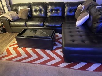 L-shaped leather sofa with chaise and matching ottoman