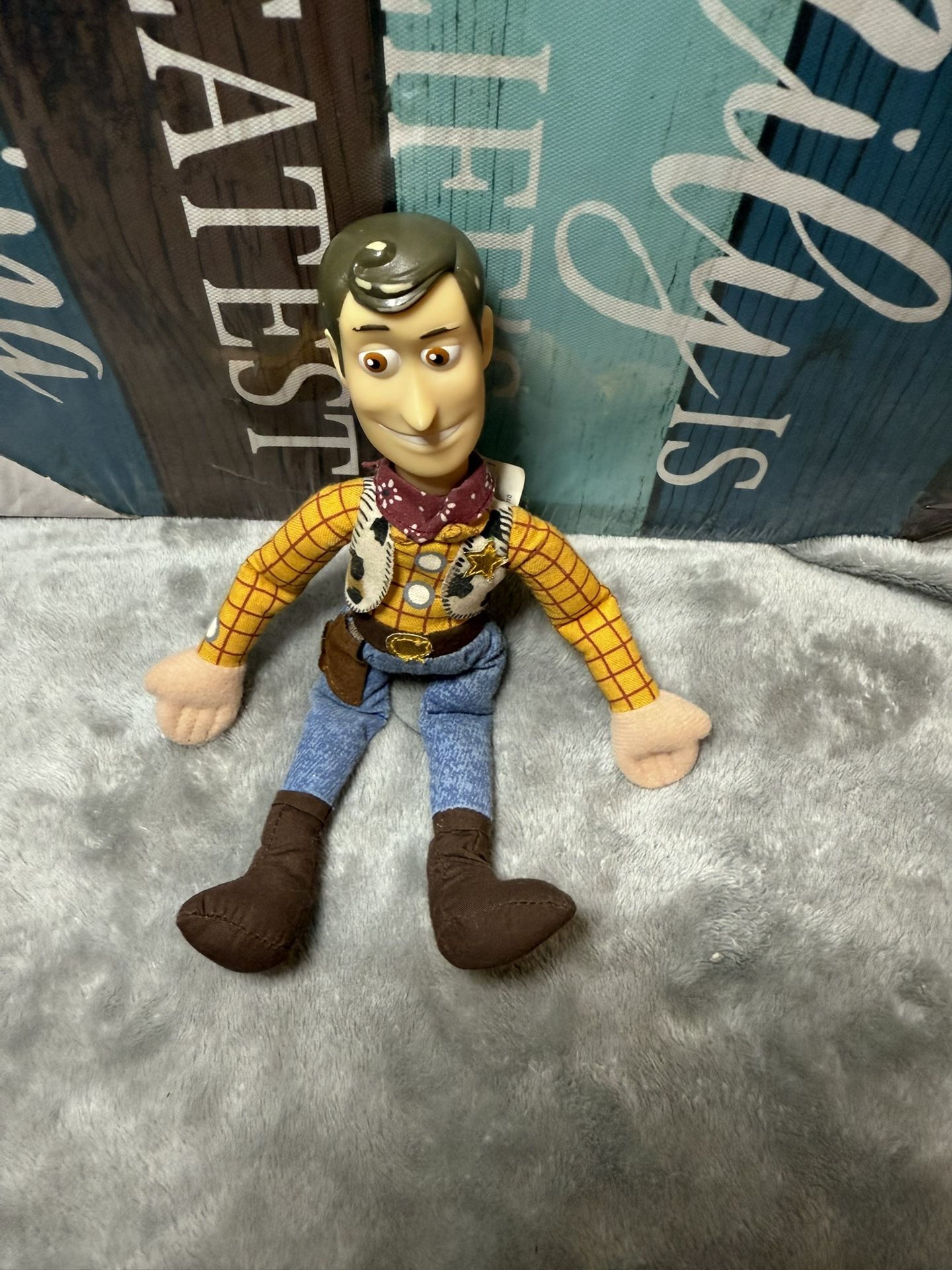 Plush toy of Woody, the iconic cowboy character from Disney Pixar's Toy Story franchise.