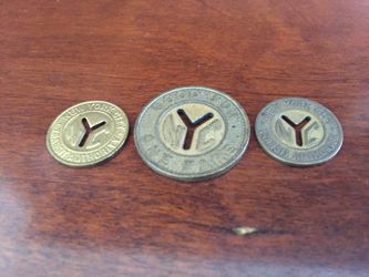 Three New York City subway fare tokens