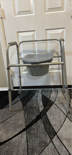 Adjustable bedside commode with removable bucket and padded cushion