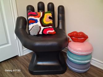 Black hand shaped chair with silver painted nails