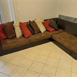 L-shaped  brown sectional with pillows