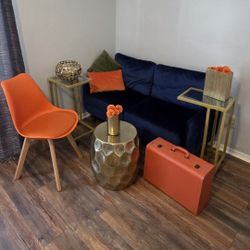 Blue Velvet Loveseat, Orange Chair, Gold Side Tables
