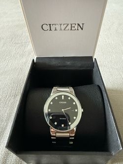 Citizen Eco-Drive watch with black dial, silver-tone bracelet, and crystal hour markers