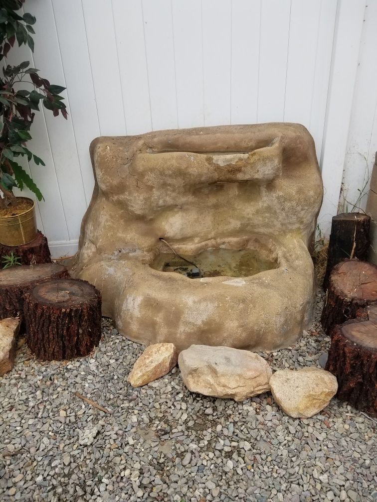 Fiberglass waterfall fountain. Works great/ good for fish/ not heavy. Easy to carry/ new hose/ comes with a pump