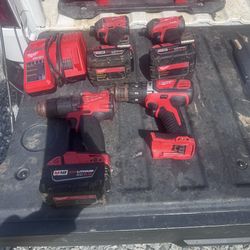 2 Milwaukee M18 FUEL impact drivers, 1 Milwaukee M18 drill/driver, 3 M18 XC 5.0 batteries, and 1 charger