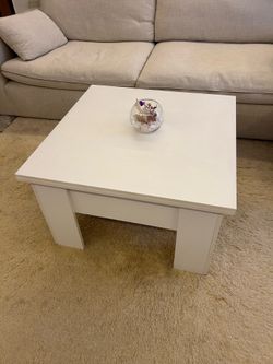 White Lift Top Coffee Table – Great Condition  Modern white coffee table with lift-top design and hidden storage compartment. Perfect for living room,