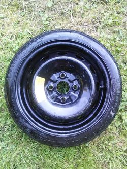Spare donut wheel and tire.