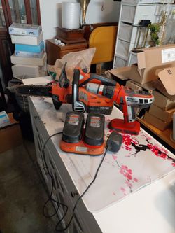Cordless chainsaw and drill with dual charging dock