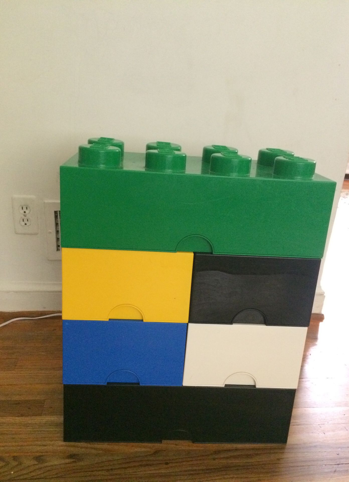 6 stackable LEGO containers filled with lego pieces and 3 LEGO boats