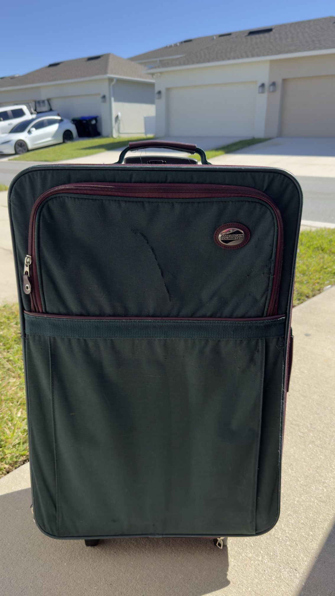Selling large checked suitcase, 29 x 18 inches.