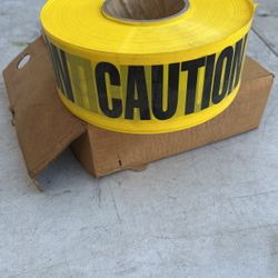 ROLL OF NEW CAUTION TAPE IN BOX