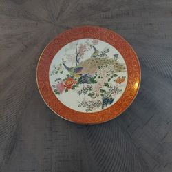 Porcelain decorative plate with peacock and floral motif in Satsuma style