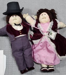 Cabbage Patch Kids 1986 Christmas Edition twins, Nigel and Hillary, feature soft cloth bodies and elaborate Victorian-style outfits.